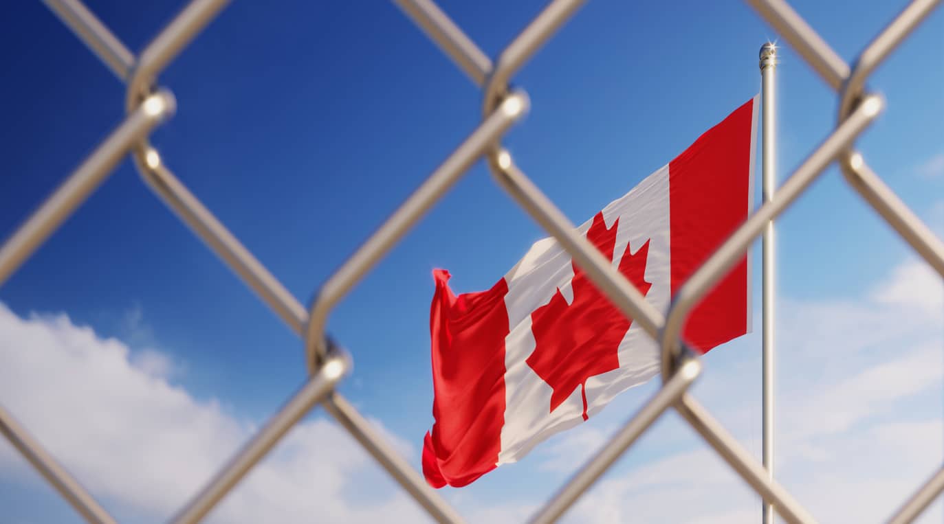 Fence In Front Of Canadian Flag